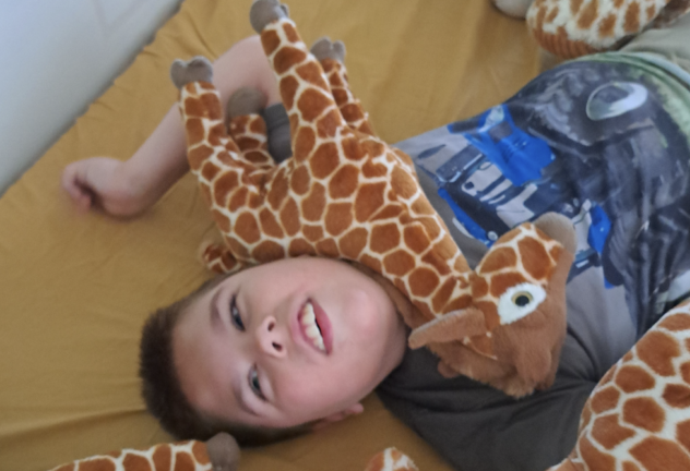 Nathan liggend met giraf